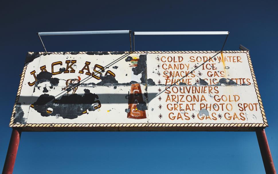 Free Image of Sign Attached to Pole Alongside Road 