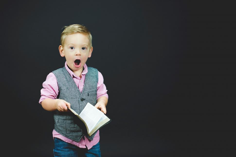 Free Image of Young Boy Holding a Book 