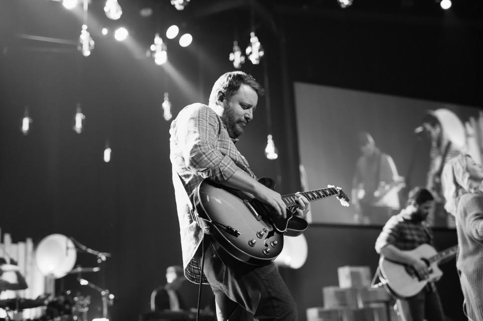Free Image of Man Playing Guitar in Black and White 