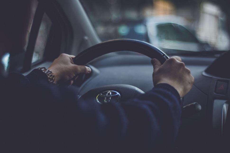 Free Image of Person Driving Car on City Street 