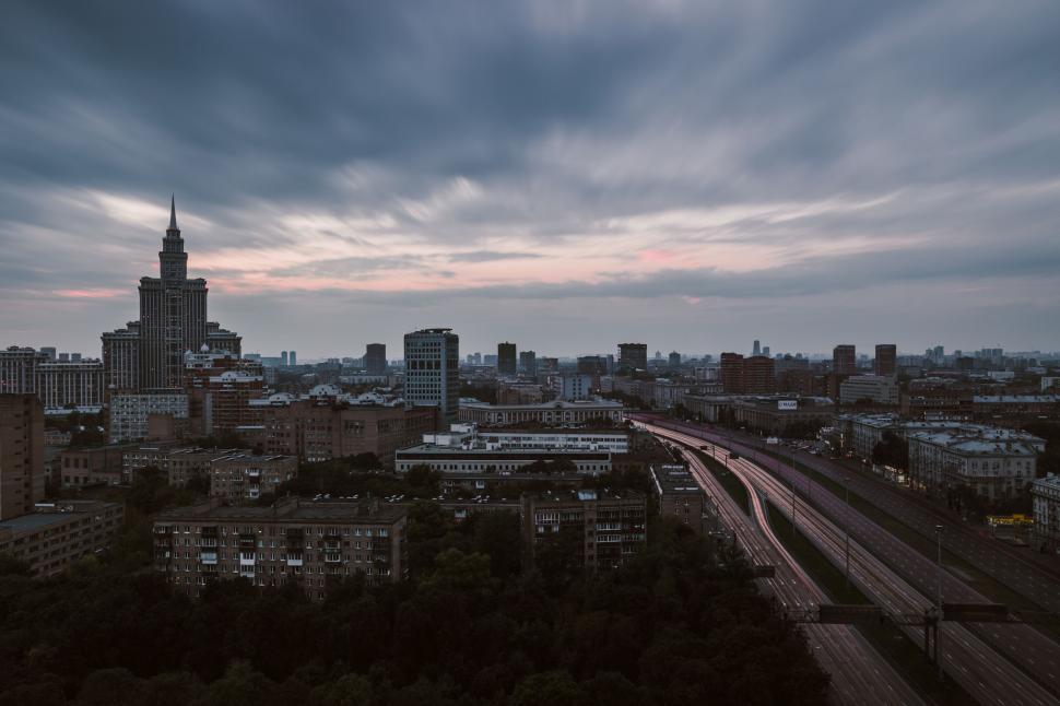 Free Image of Aerial View of City With Train on Tracks 