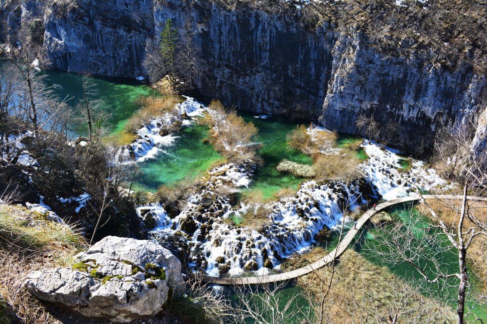 Free Image of Snow Covered Rocks Surrounding River 