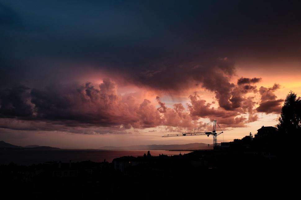 Free Image of Cloudy Sky With Distant Crane 