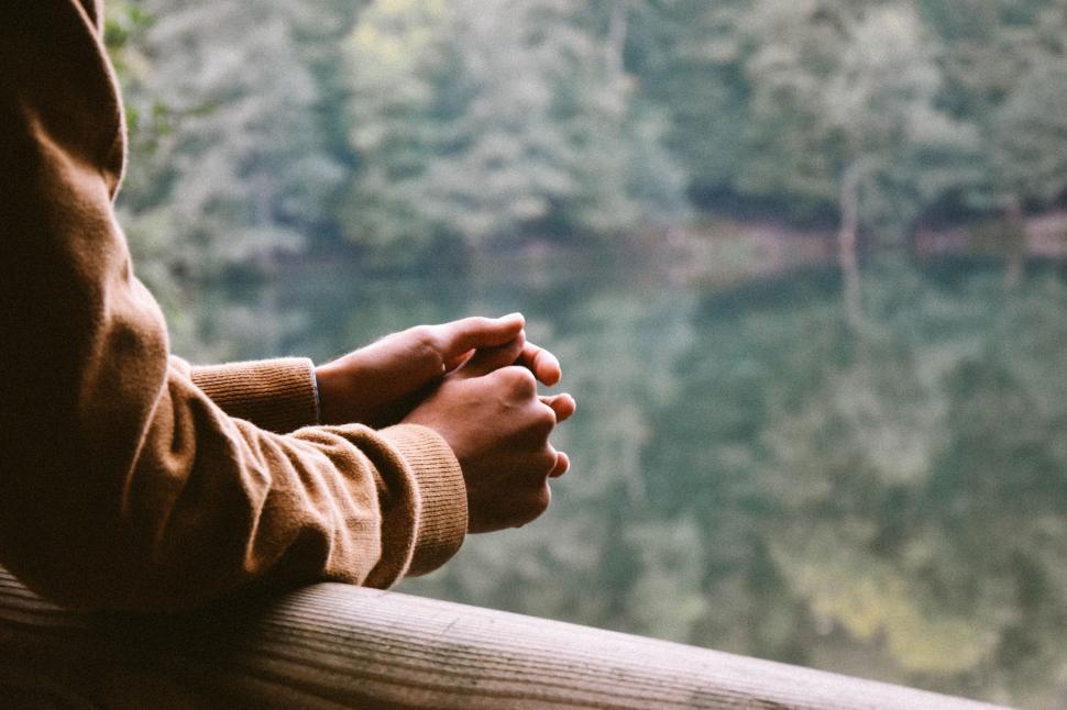 Free Image of Person Holding Hands on Railing 
