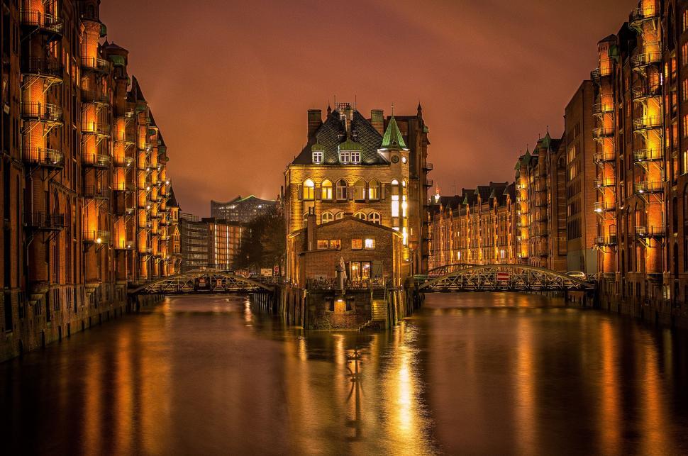 Free Image of River Flowing Through City Among Tall Buildings 