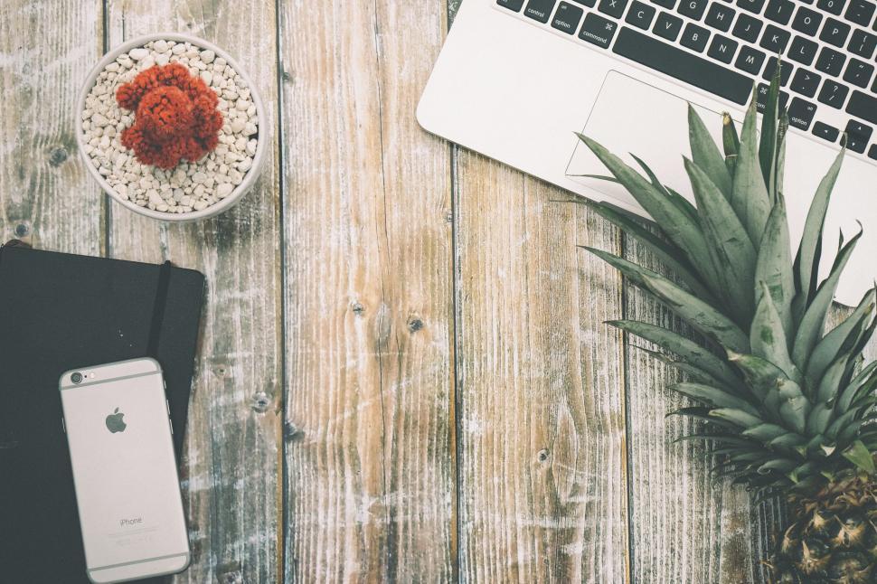 Free Image of Pineapple and Laptop on Wooden Table 