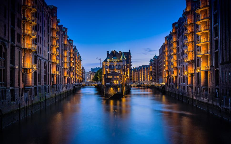 Free Image of River Running Through City Next to Tall Buildings 