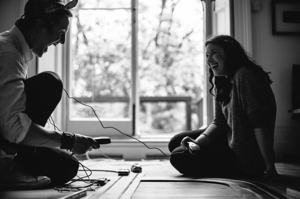 Free Image of Man and Woman Playing Video Game on Floor 