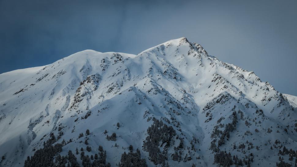 Free Image of Snow-Covered Mountain Under Cloudy Sky 