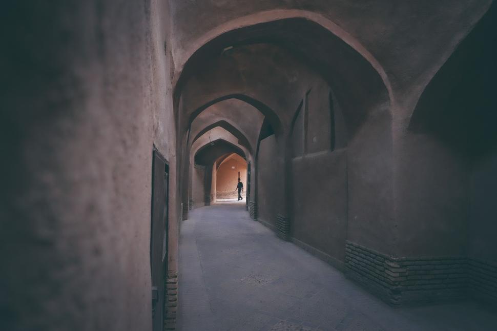 Free Image of Person Walking Down a Narrow Alleyway 