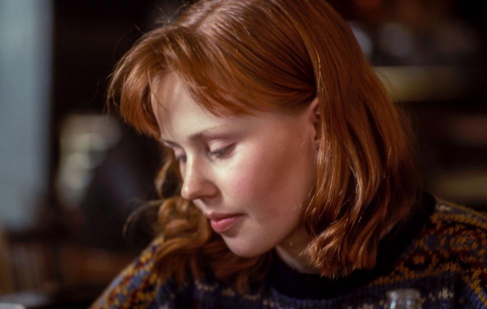 Free Image of Woman With Red Hair Looking at Cell Phone 