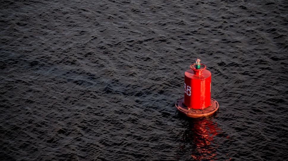 Free Image of Red Buoy Floating on Body of Water 