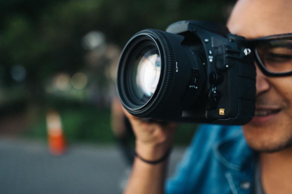 Free Image of Man Holding Camera to Face 