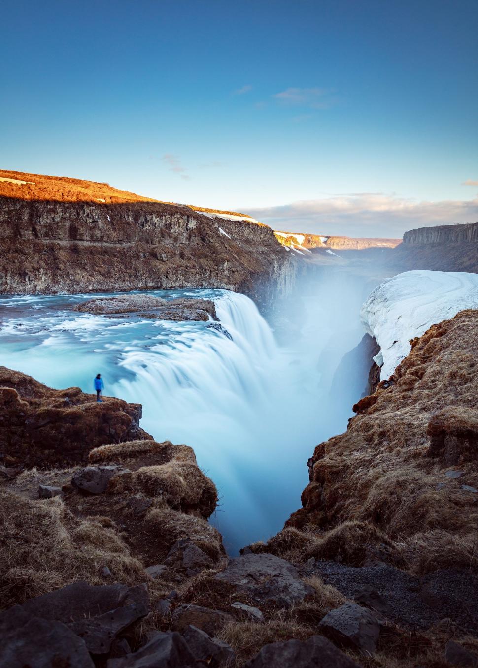 Free Image of Man Standing at Edge of Waterfall 