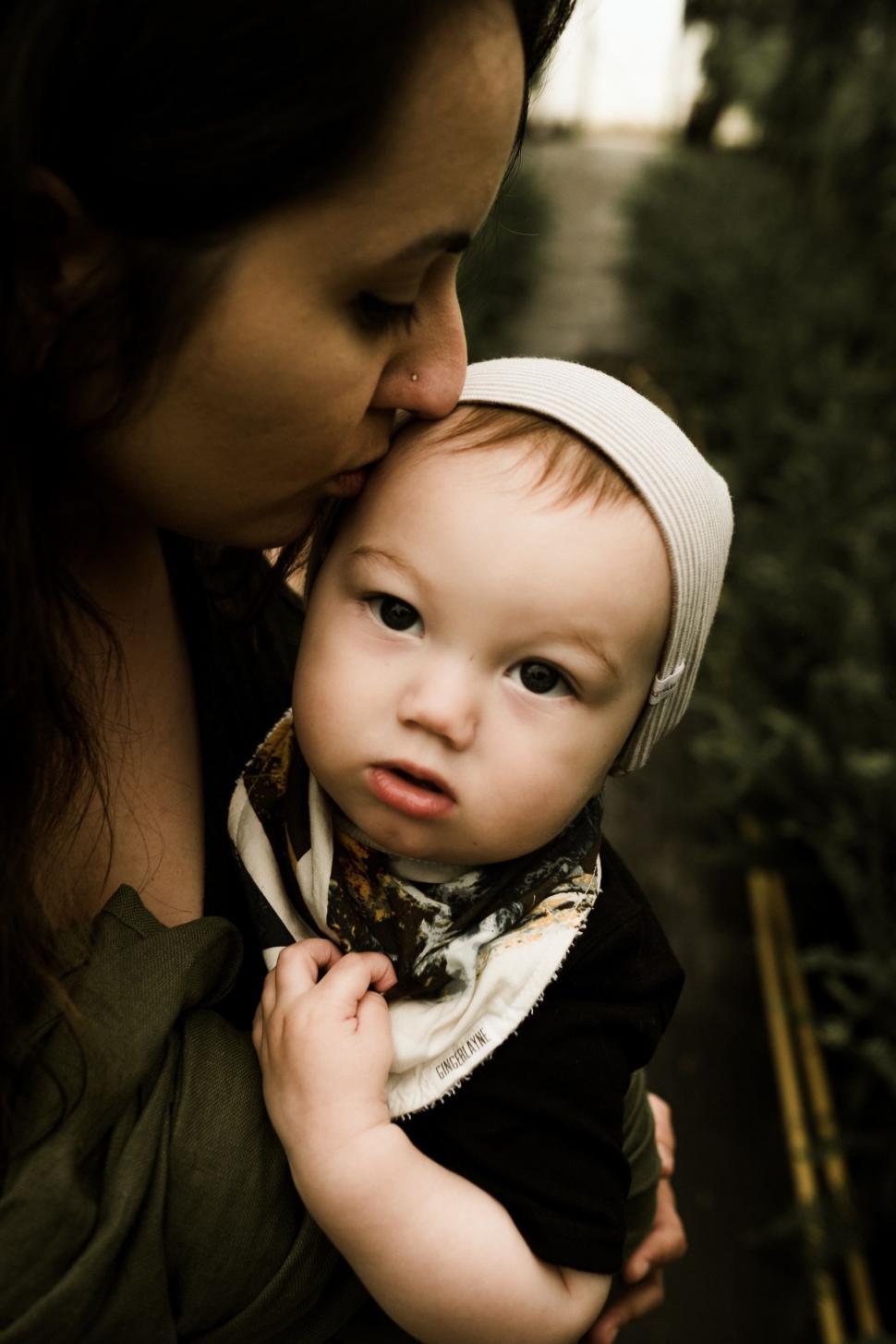 Free Image of Woman Holding Baby in Her Arms 