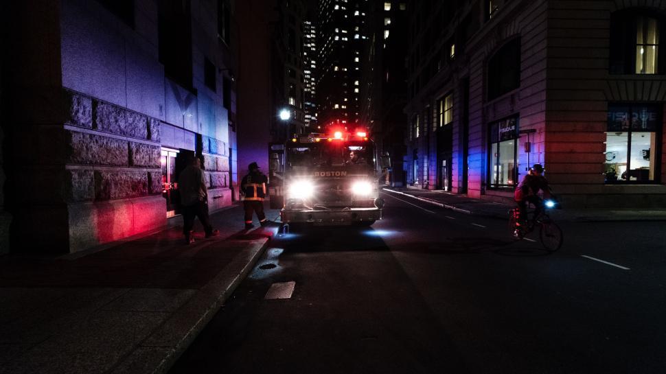Free Image of City Street at Night With Red Light On 