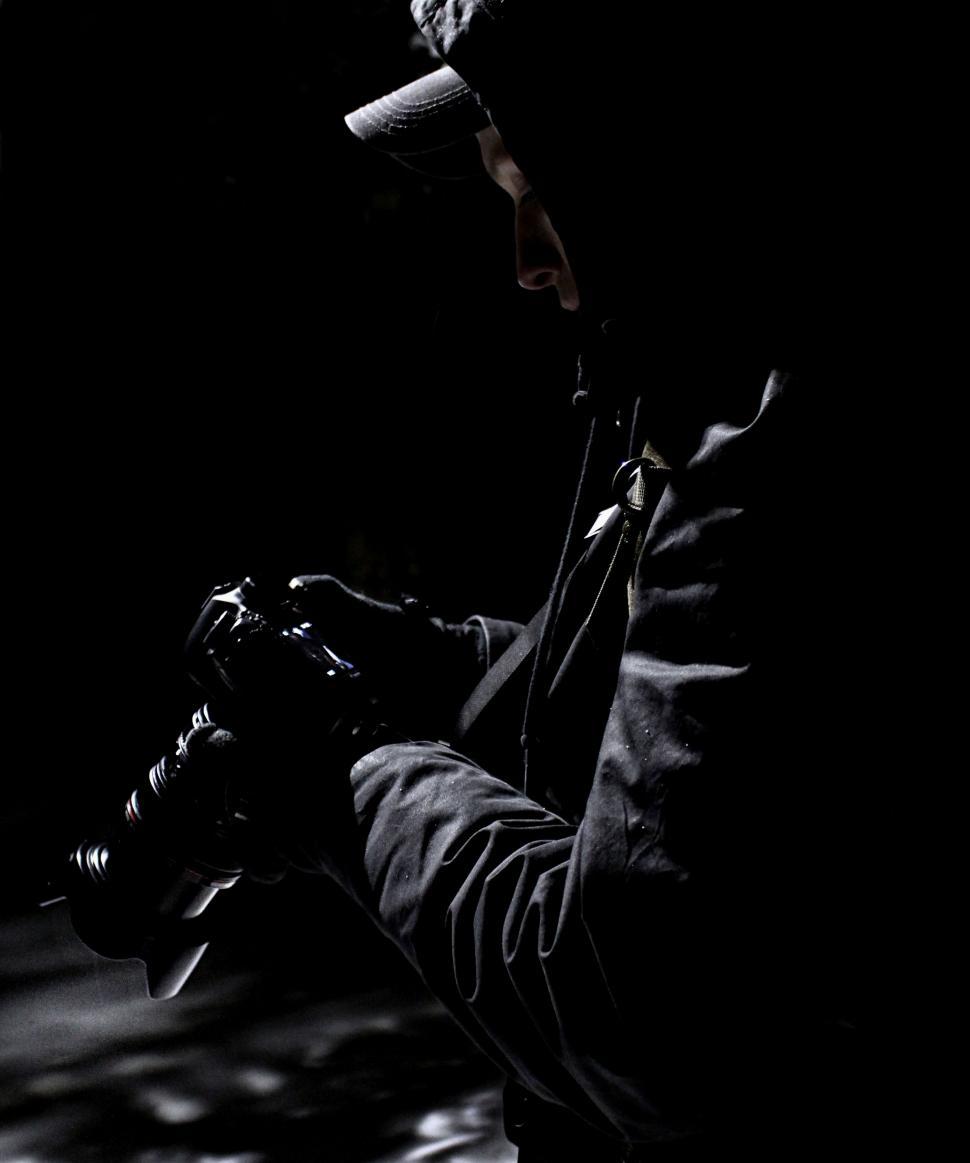 Free Image of Man Holding Camera in Black and White 