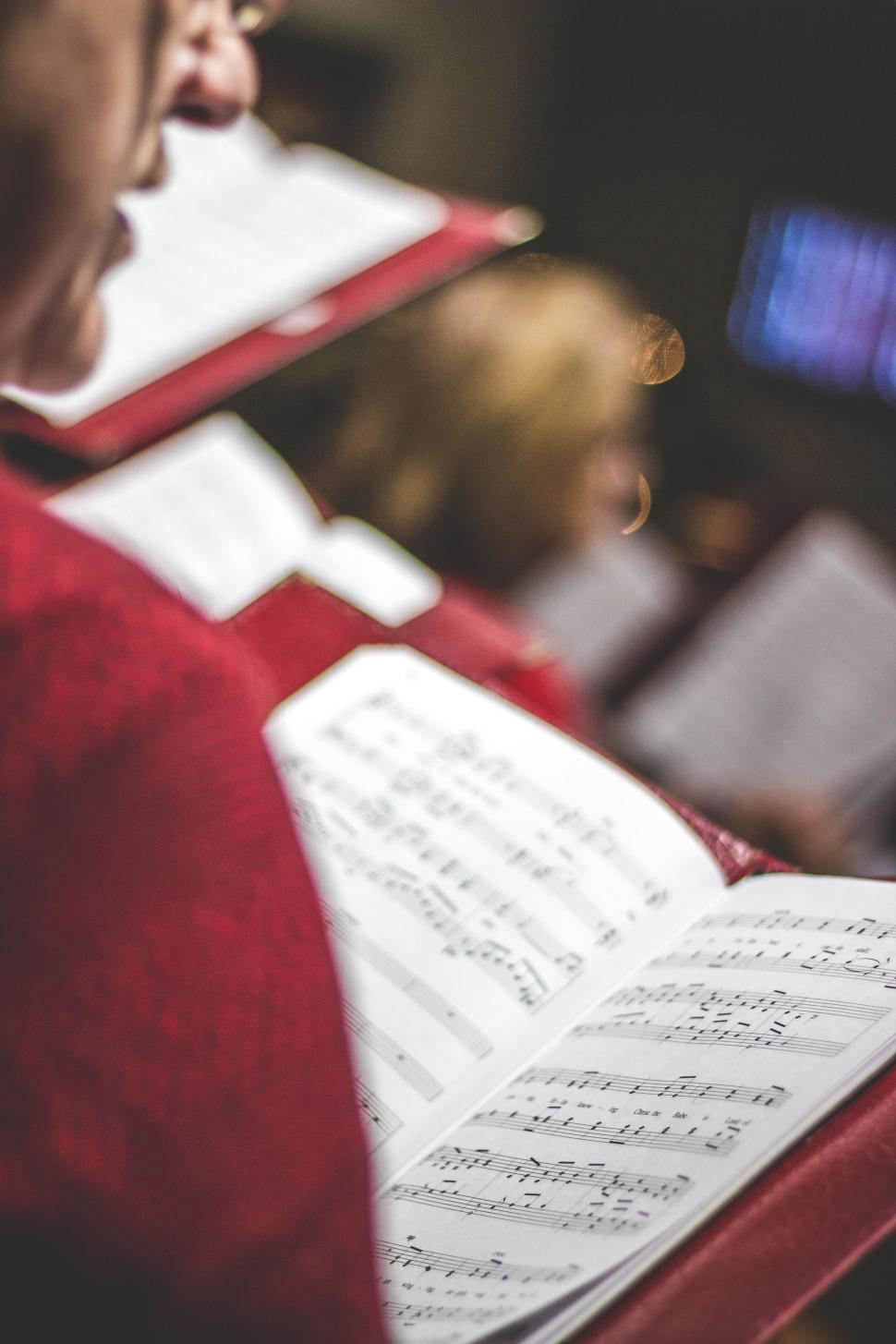 Free Image of Person in Red Shirt Holding Book 