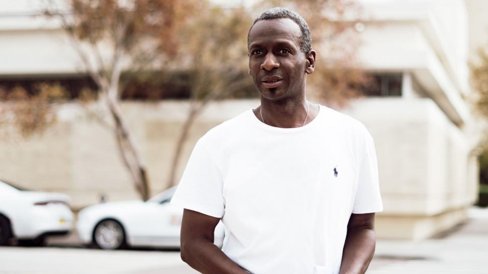 Free Image of Man in White Shirt Standing on Street 