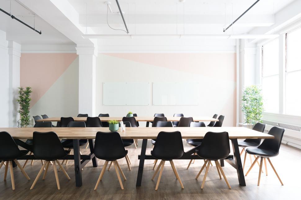 Free Image of Long Table With Black Chairs in a Large Room 
