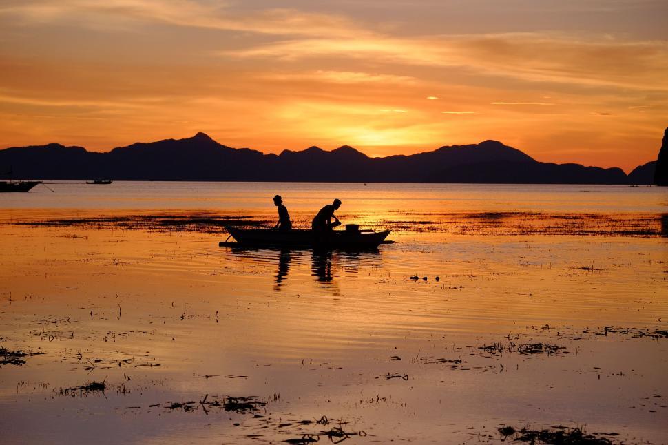 Free Image of People in Small Boat on Water 