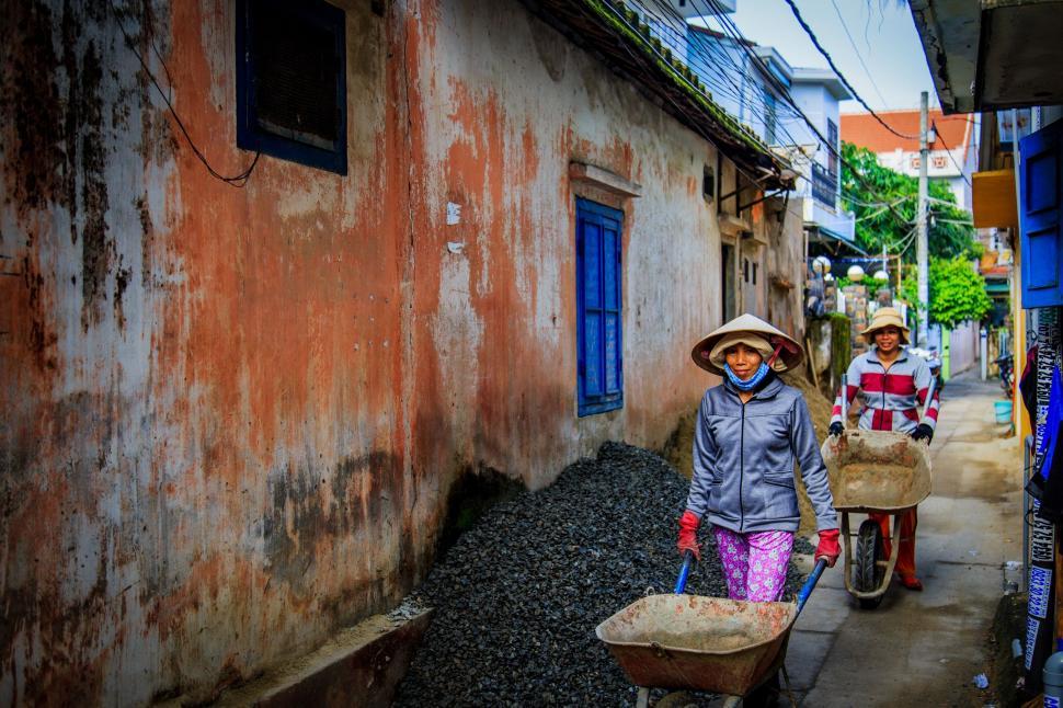 Free Image of Woman Walking Next to Building 