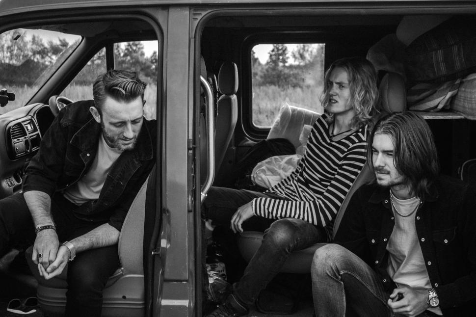 Free Image of Group of People Sitting in the Back of a Van 
