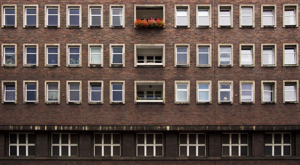 Free Image of Tall Brick Building With Many Windows 