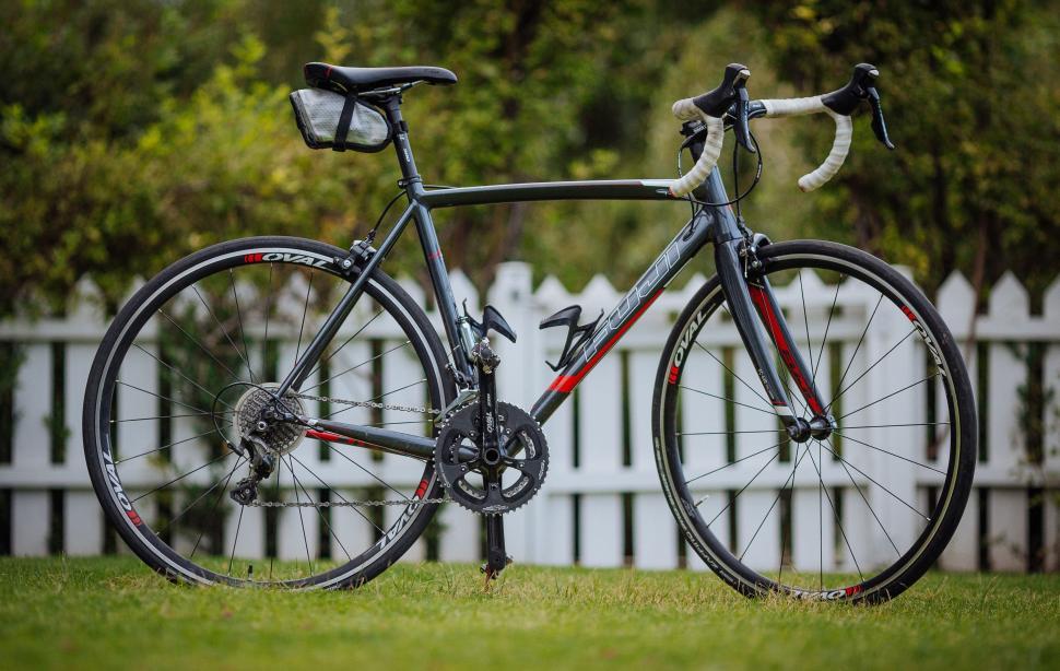Free Image of Bicycle Parked in Front of White Picket Fence 