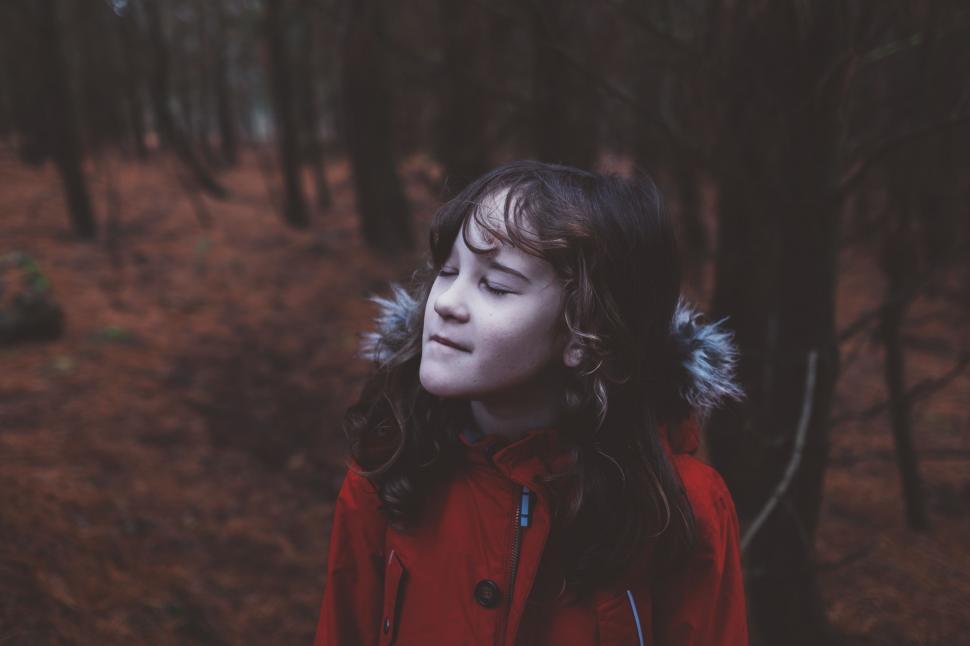 Free Image of Woman in Red Coat Standing in Forest 