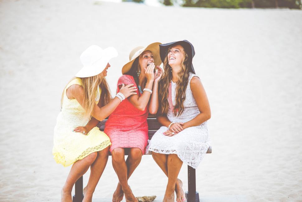 Free Image of Group of Women Sitting on Top of a Bench 