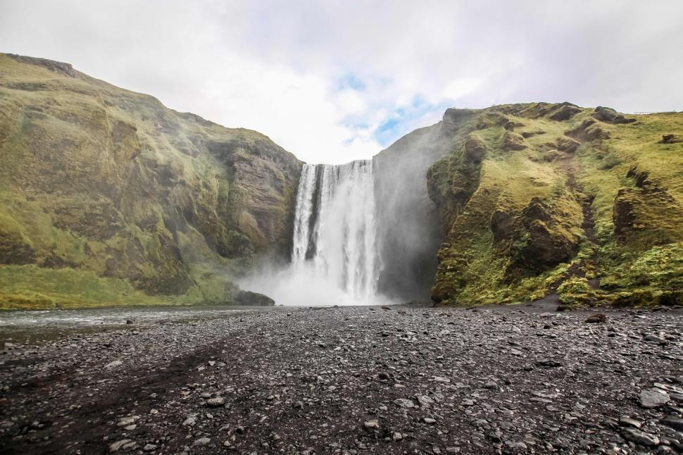 Free Image of Majestic Waterfall in Rocky Terrain 