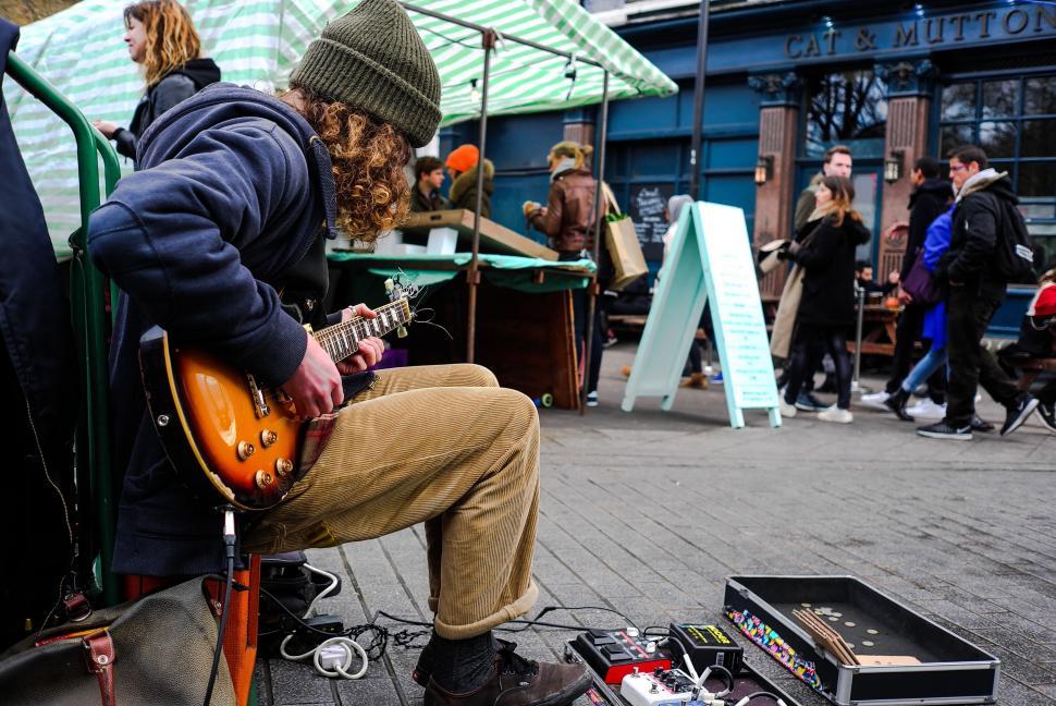 Free Image of Man Playing Guitar on Bench 