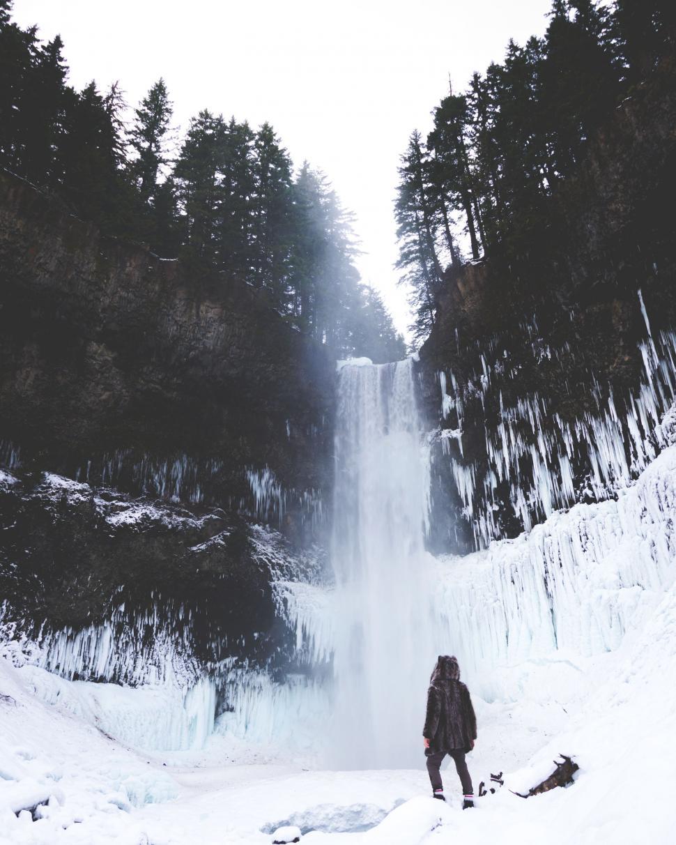 Free Image of Person Standing in Front of Waterfall 