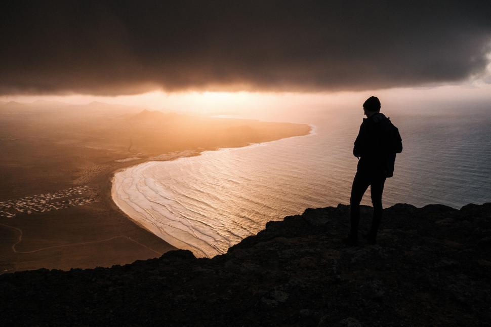 Free Image of Person Standing on Hill Overlooking Ocean 