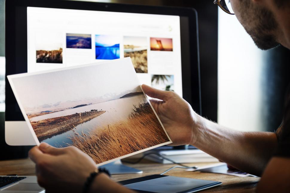 Free Image of Man Viewing Picture on Computer Screen 
