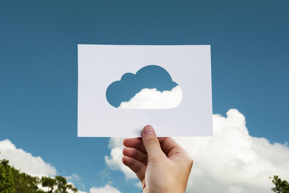 Free Image of Hand Holding Paper Cut Out of a Cloud 