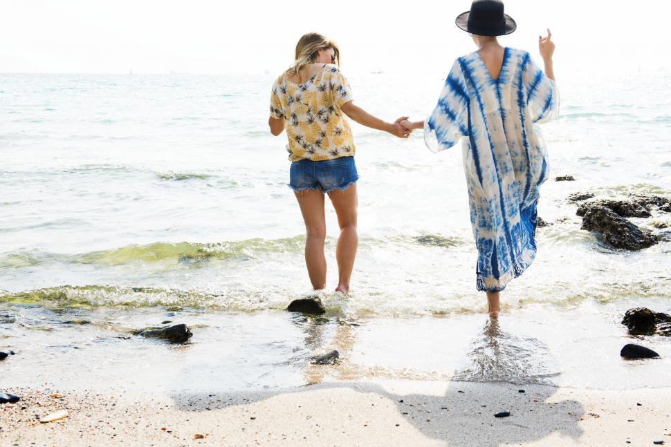 Free Image of Couple Walking in the Water 