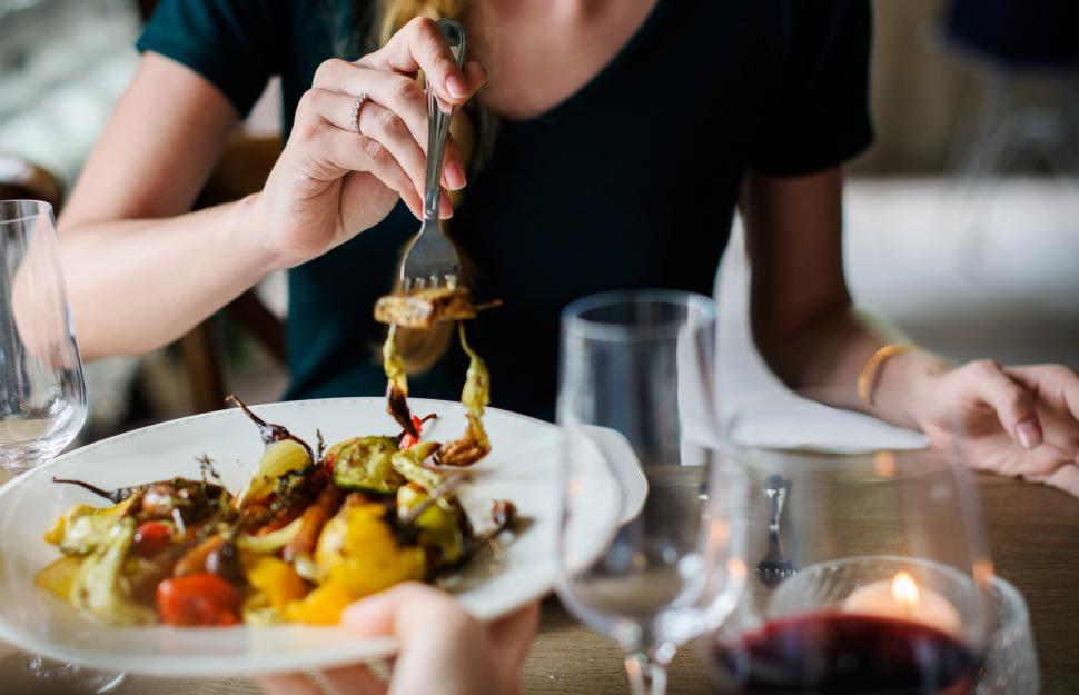 Free Image of Woman Eating Plate of Food With Fork 
