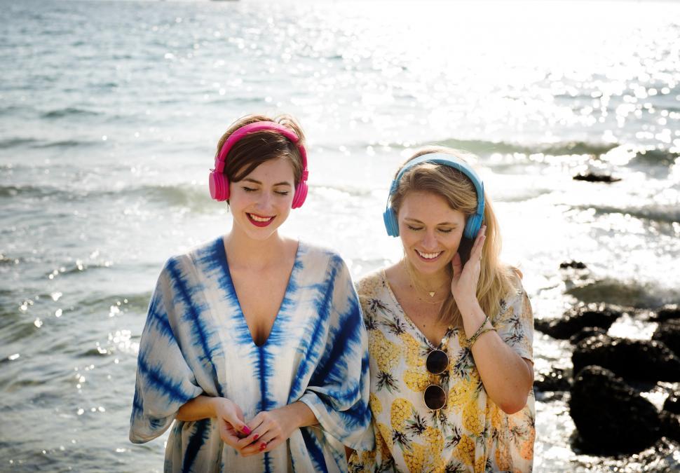 Free Image of Two Women Standing Near Ocean 