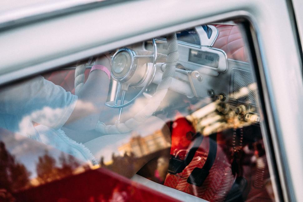 Free Image of Reflection of a Person in a Car Window 