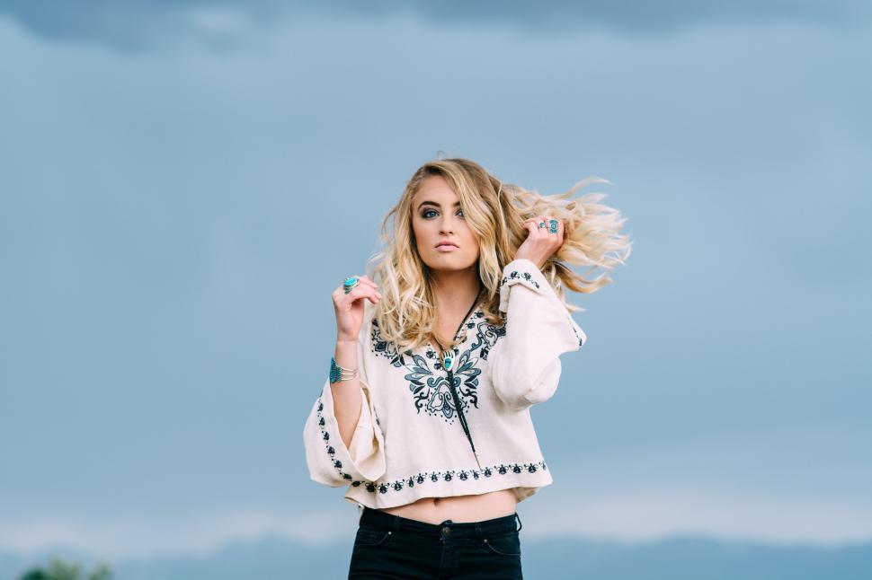 Free Image of Woman Standing on Top of Grass Covered Field 