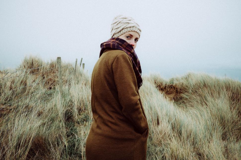 Free Image of Person Standing on Top of a Grass Covered Hill 