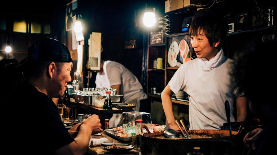 Free Image of Man Standing in Front of Table Filled With Food 
