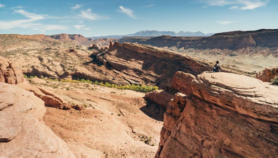 Free Image of Man Standing on Top of Large Cliff 