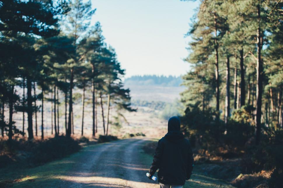 Free Image of Person Riding Bike Down Dirt Road 