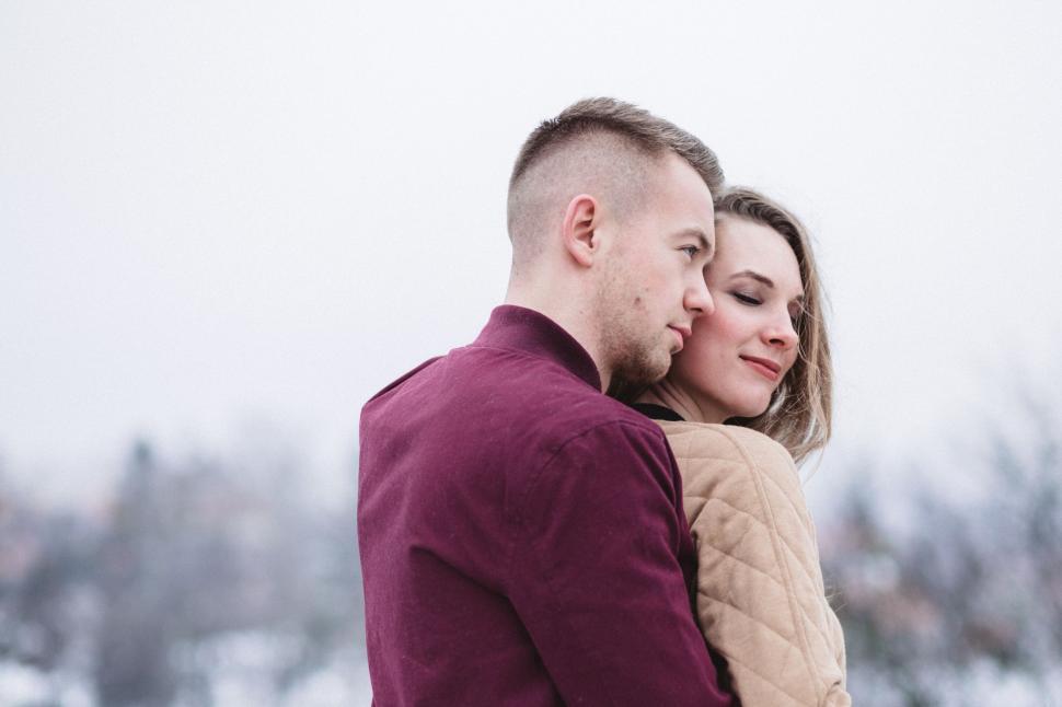 Free Image of Man and Woman Embracing in the Snow 