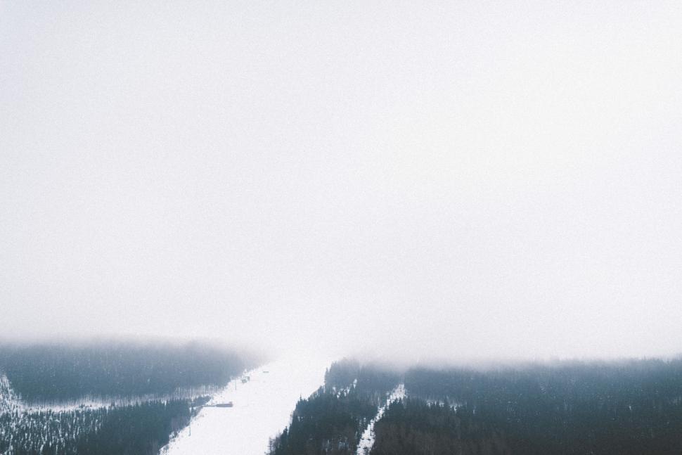Free Image of Man Snowboarding Down Snow Covered Slope 