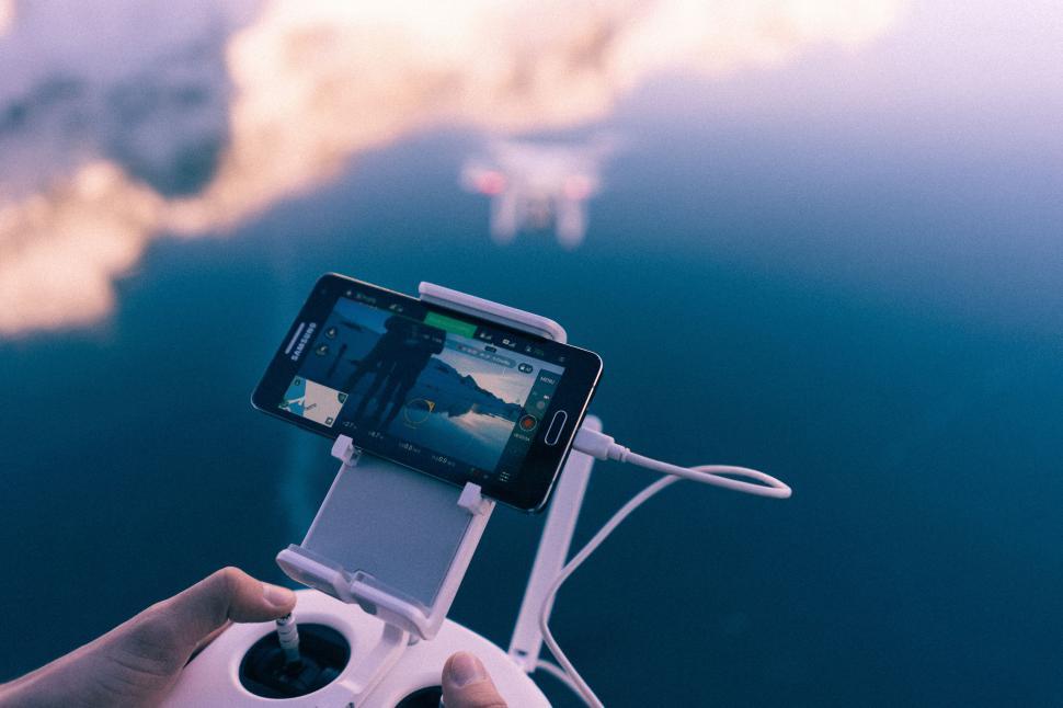 Free Image of Person Holding Game Controller and Cell Phone 