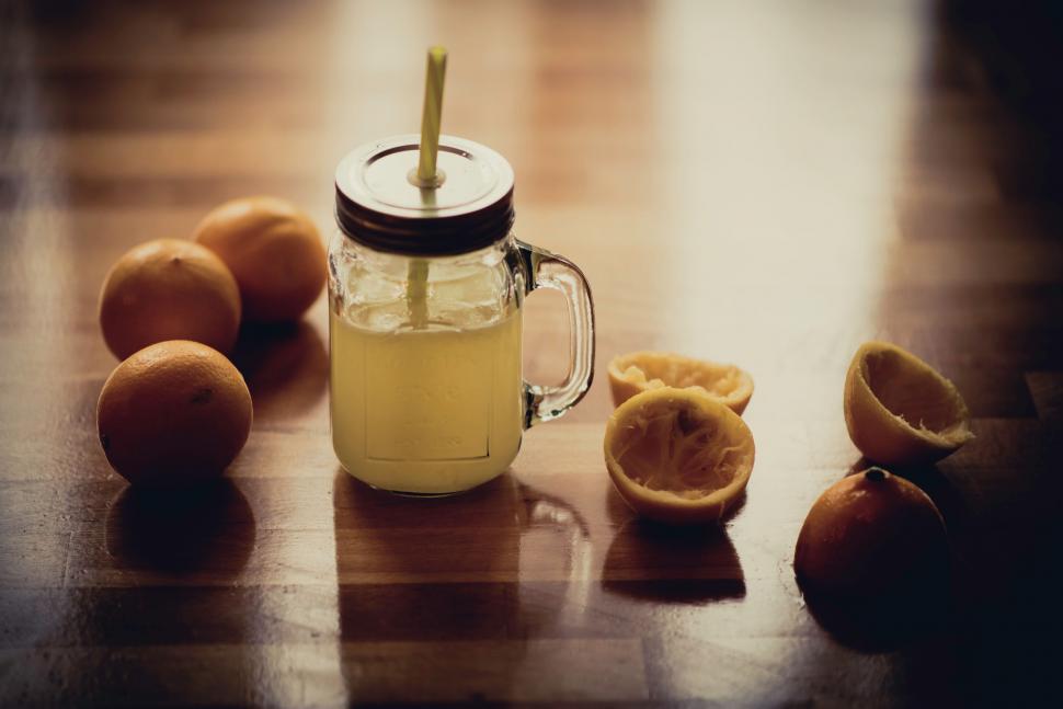 Free Image of Glass Jar Filled With Liquid on Wooden Table 